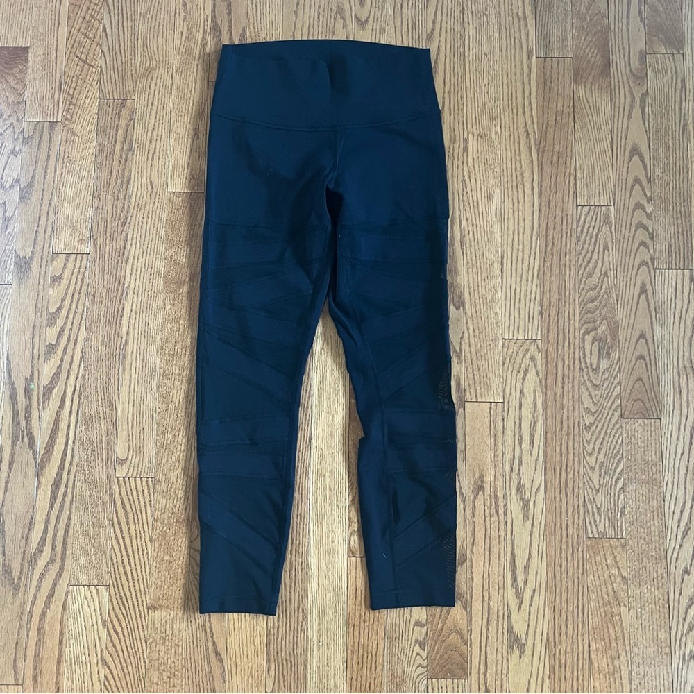 Black Lulu Lemon Leggings with See-Thru Pattern.